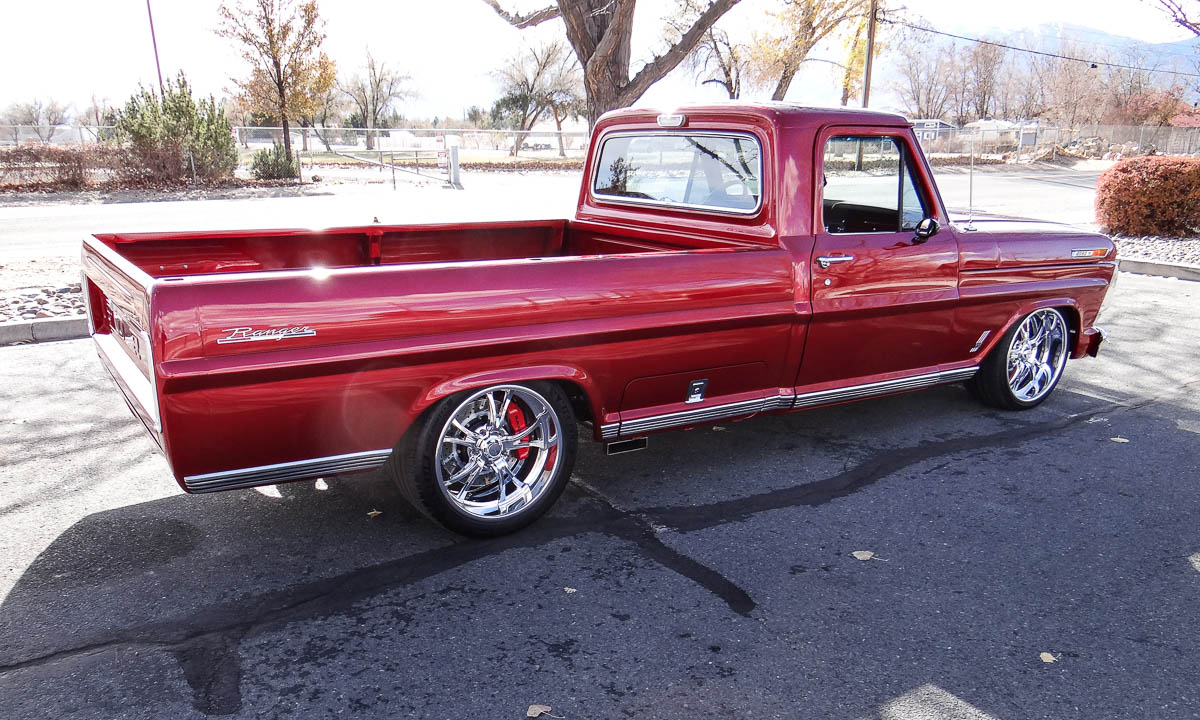 Rear view of the truck showing tubbed wheel wells and the massive 345/30ZR20 Michelin tires.