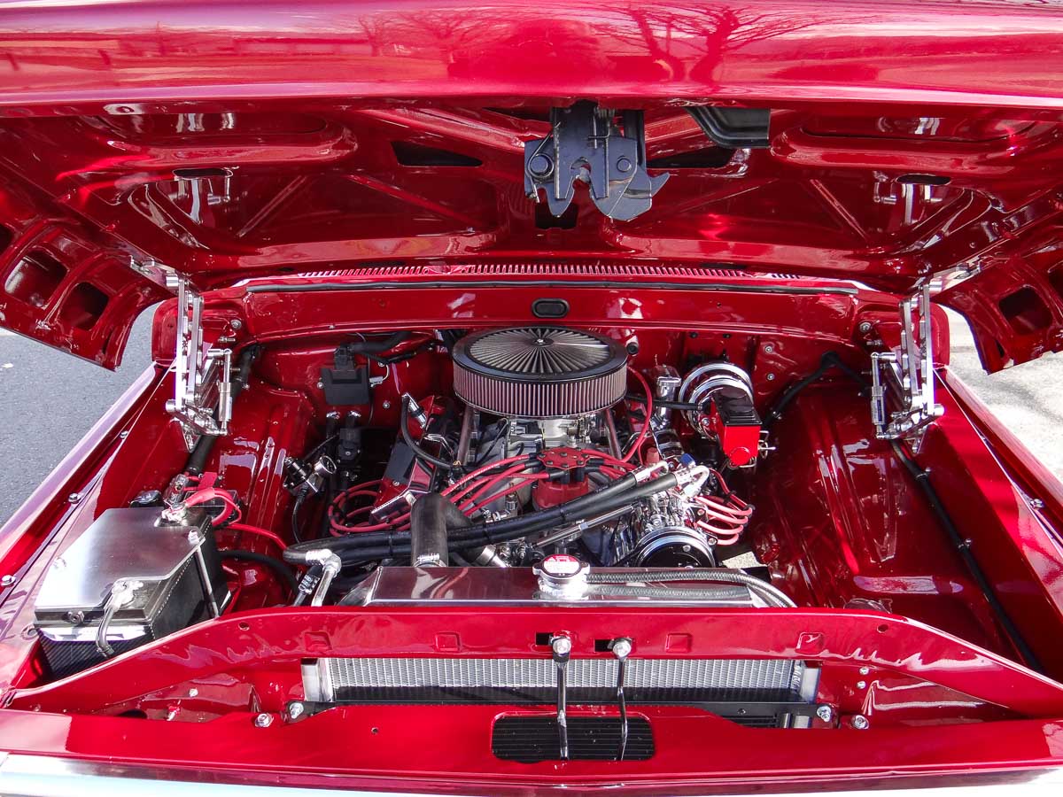 Close-up of the Ford FE 449 stroker engine in Ginger, featuring Edelbrock Pro-Flo 4 fuel injection and custom stainless steel exhaust.