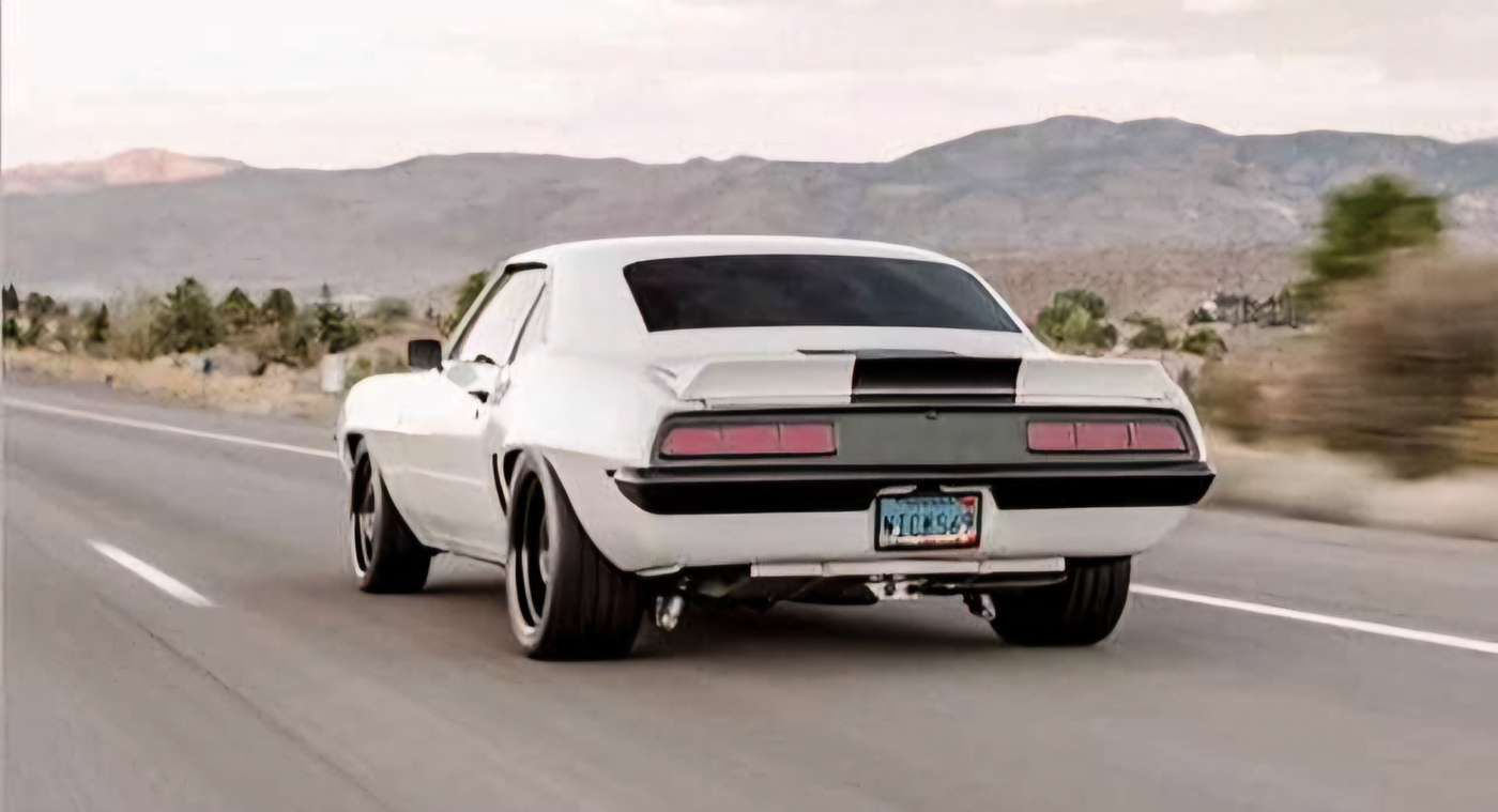 ction shot of Nick driving his 1969 Camaro on a sunny Reno street.