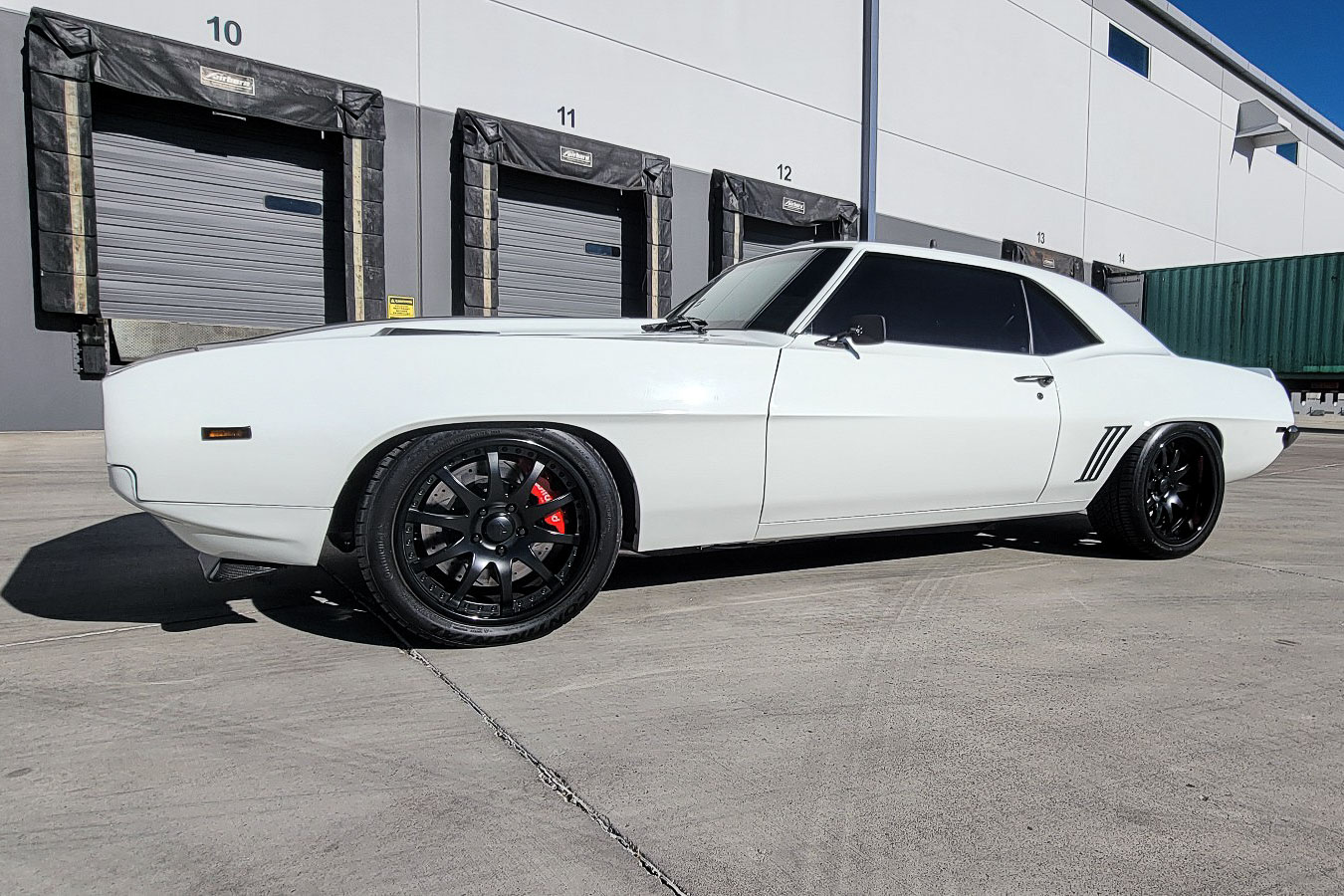 Front view of Nick Scotto’s 1969 Camaro showcasing its sleek Summit Racing pure white paint and carbon fiber hood.