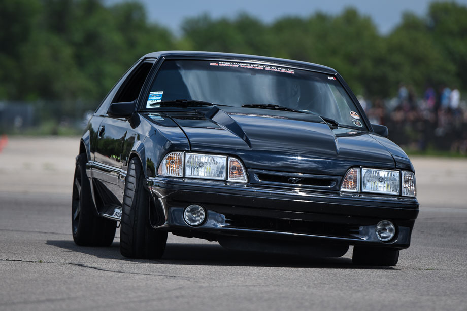 A Fox body Ford Mustang on the QA1 autocross course.