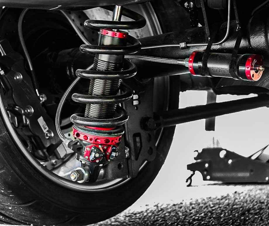 Close-up of QA1 MOD shocks’ modular valve packs and adjustment knobs, ideal for precision suspension tuning in drag racing and road courses. Close-up of QA1 MOD shocks’ modular valve packs and adjustment knobs, ideal for precision suspension tuning in drag racing and road courses.