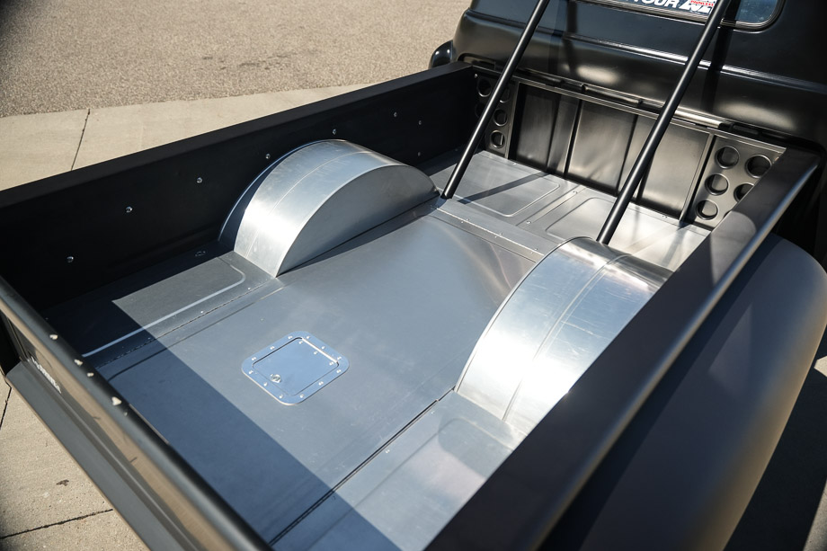 The custom bead-rolled aluminum bed floor of the 1956 Chevy 3100 with center access door.